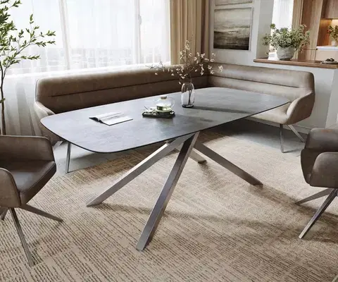 Jedálenské stoly DELIFE Jedálenský stôl Edge zaoblený 200x100 cm keramika betónová sivá krížová podstava obdĺžniková nerezová oceľ
